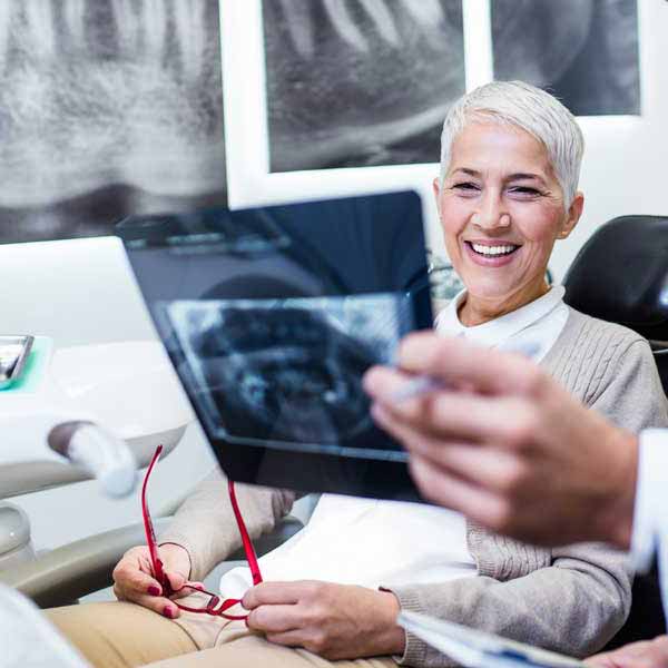 A doctor showing a patient dental x-rays